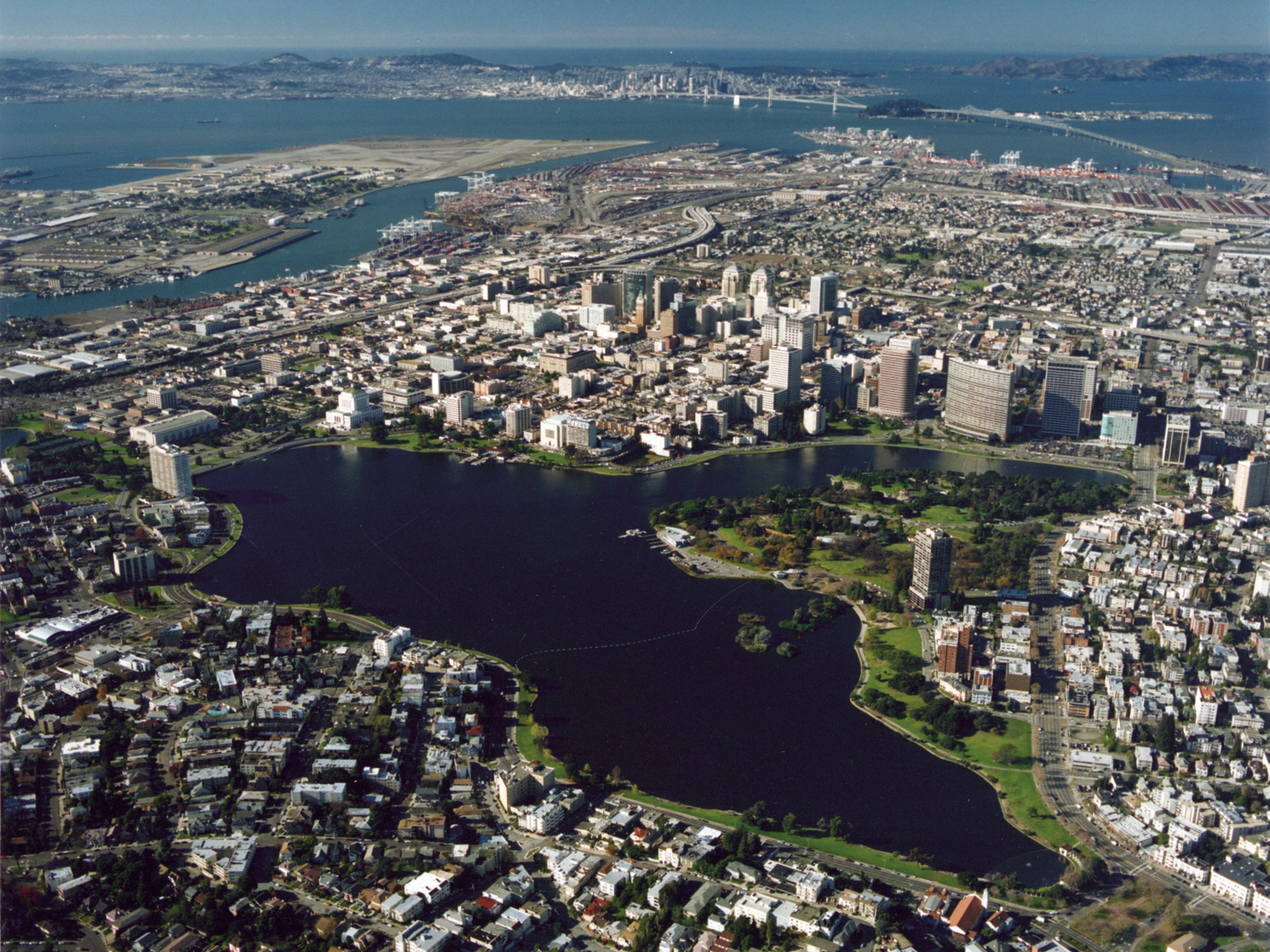 Aerial view of an urban cityscape framing a central lake