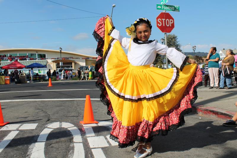 A girl in a traditional Mexican blouse and skirt